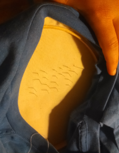 Backside of working fabric, with straight-pin ends visible