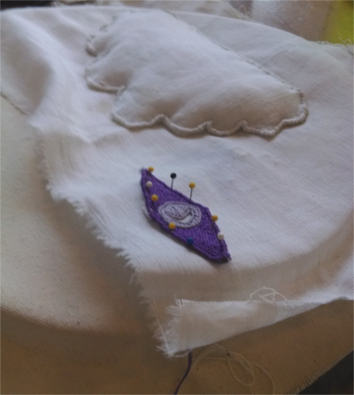 Side view of the cloud element completed; the presence of batting is obvious from the convex shape of the cloud.