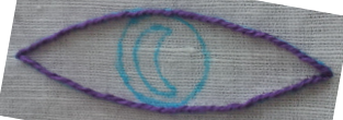 An outline of the Welcome to Night Vale logo traced onto linen with water-soluble marker.  The outermost outline has been further outlined with outline stitch in a vibrant purple which approximates the prominent color of the original design.