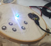 A seven-LED circuit, with power and ground lines populated throughout. Data is populated for two LEDs, which are lit.