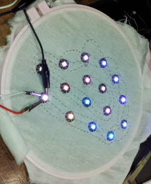 Sixteen LEDs in a cloud shape, lit with random colors